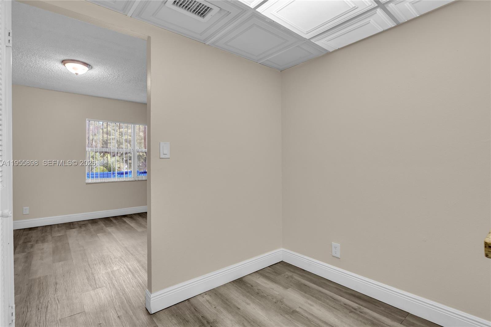 17901 Northwest 68th Avenue, Unit T206 Hialeah, FL 33015 - Photo 9 of 27 a view of empty room with wooden floor