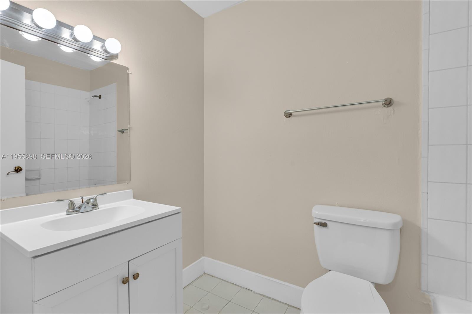 17901 Northwest 68th Avenue, Unit T206 Hialeah, FL 33015 - Photo 10 of 27 a bathroom with a toilet a sink and mirror