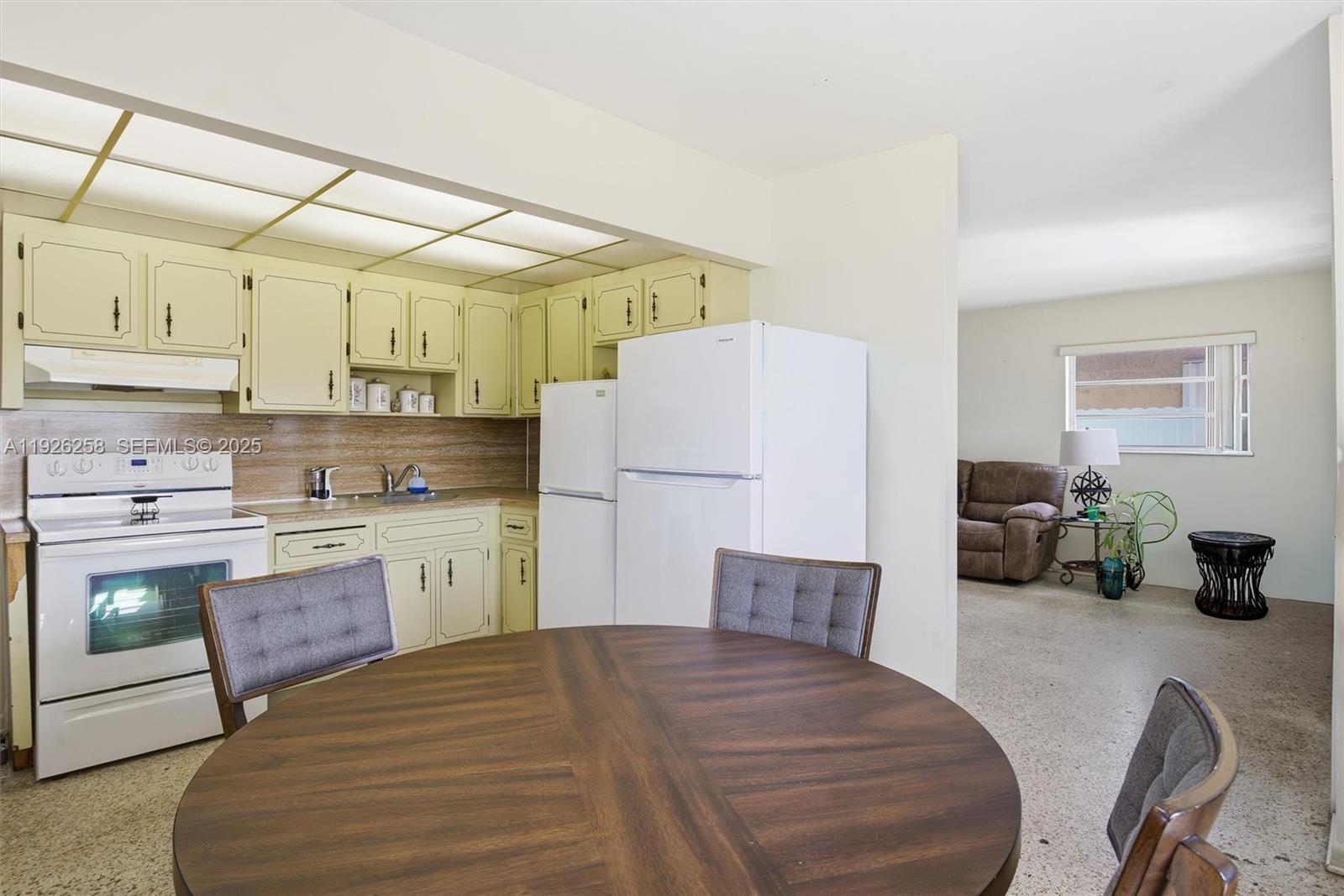 10551 Southwest 27th Street Miami, FL 33165 - Photo 14 of 35 a kitchen with a refrigerator and a sink