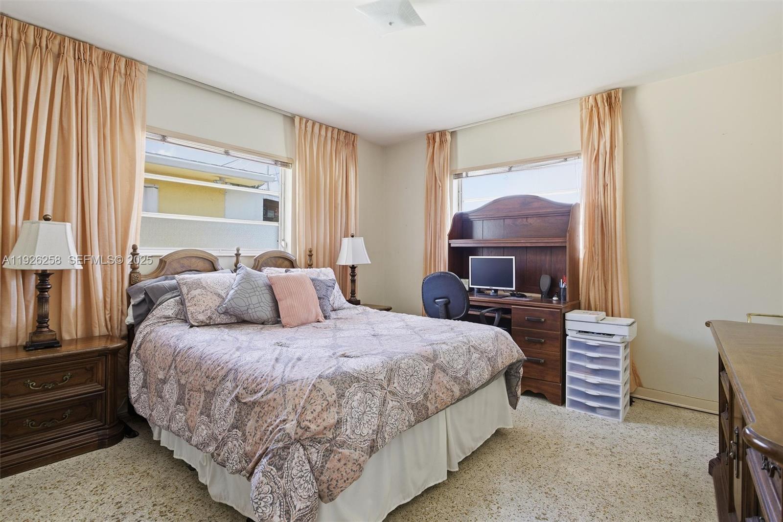 10551 Southwest 27th Street Miami, FL 33165 - Photo 16 of 35 a bedroom with a bed and a chandelier