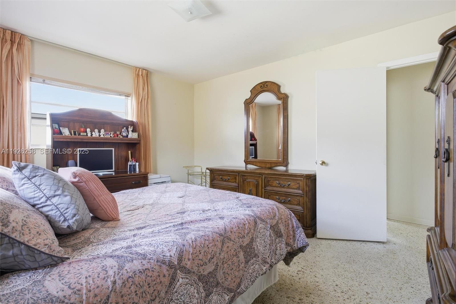 10551 Southwest 27th Street Miami, FL 33165 - Photo 18 of 35 a bedroom with a bed and a dresser