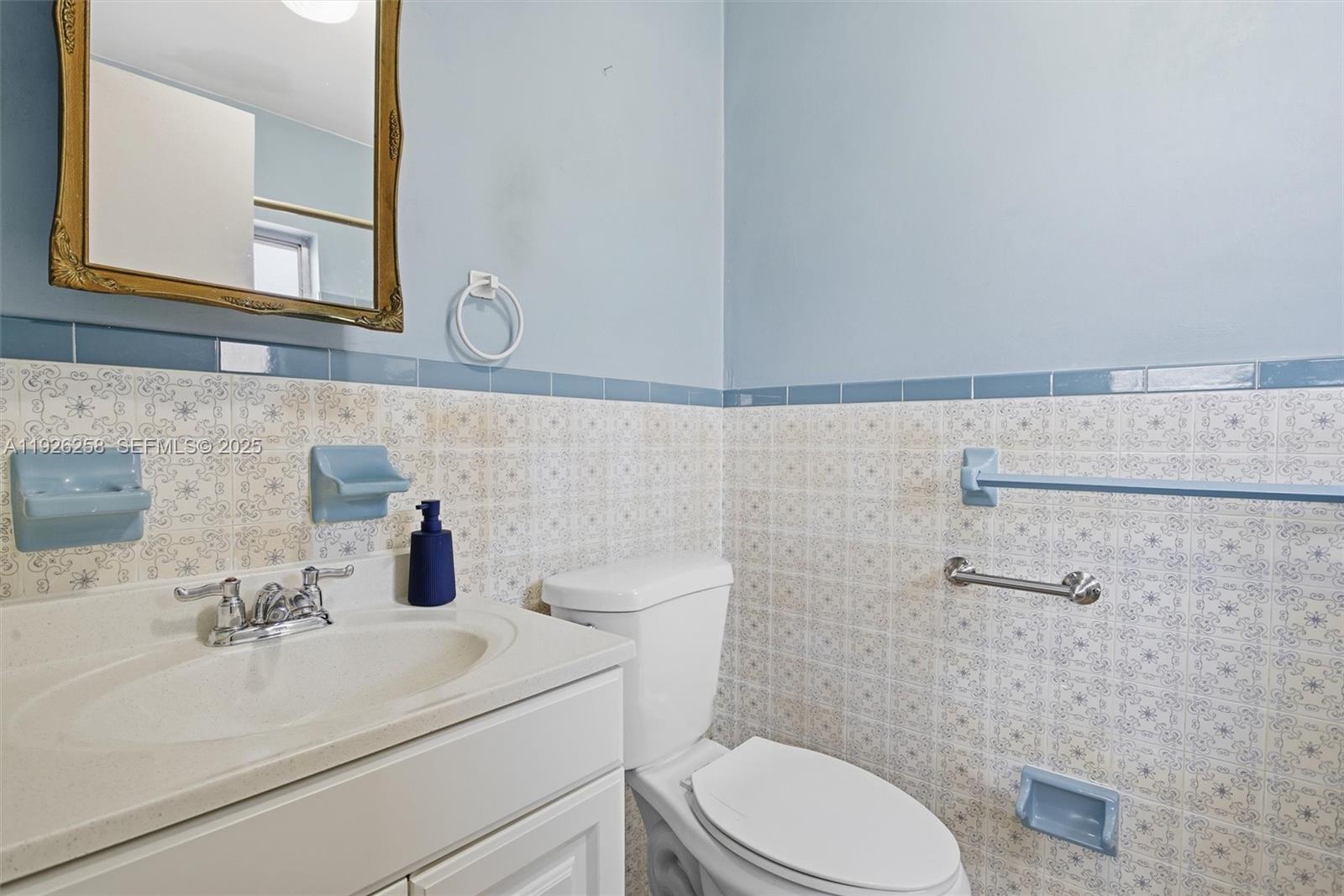 10551 Southwest 27th Street Miami, FL 33165 - Photo 19 of 35 a bathroom with a sink a toilet and mirror