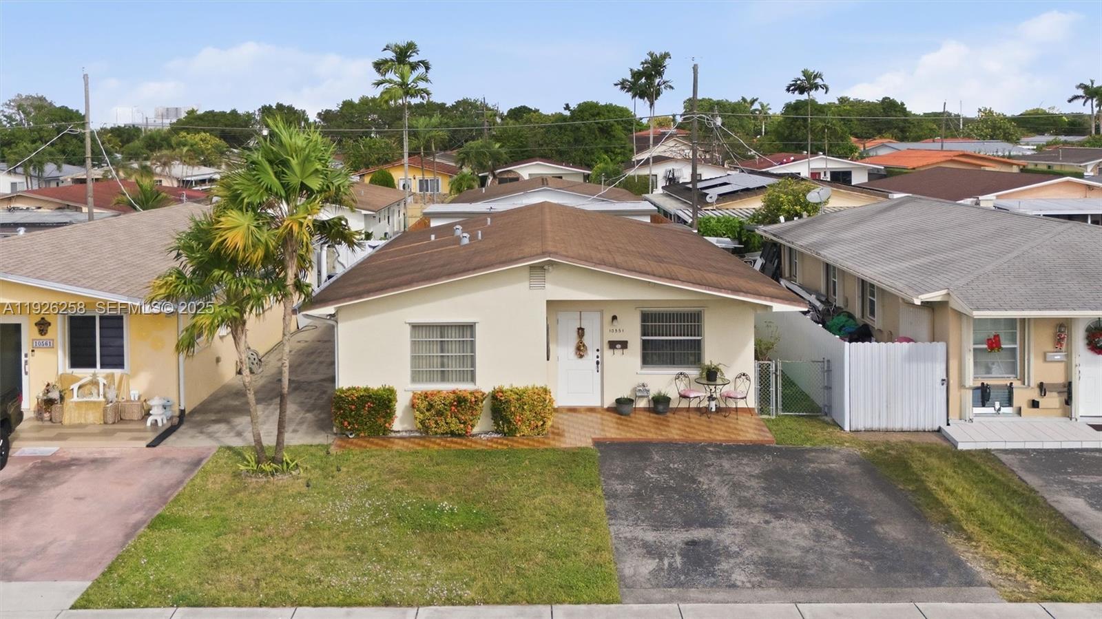 10551 Southwest 27th Street Miami, FL 33165 - Photo 2 of 35 a front view of house with yard and green space