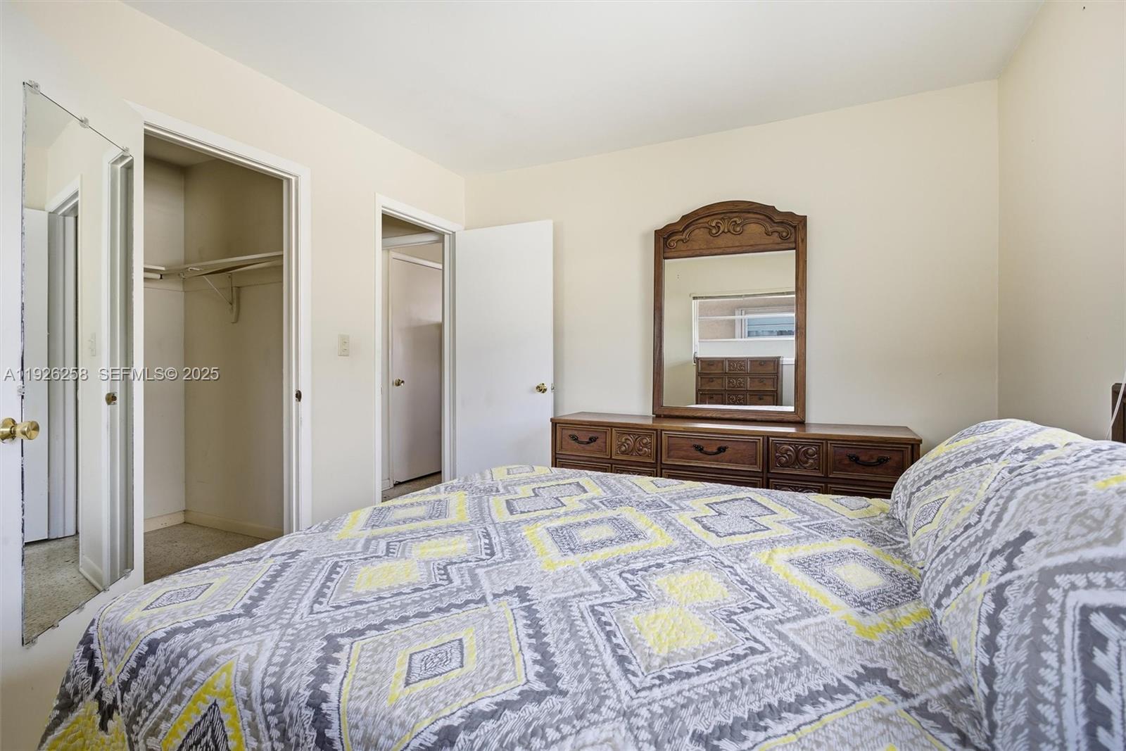 10551 Southwest 27th Street Miami, FL 33165 - Photo 22 of 35 a bedroom with a bed and a mirror