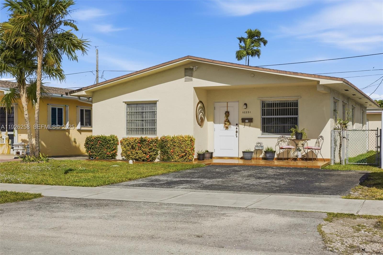 10551 Southwest 27th Street Miami, FL 33165 - Photo 3 of 35 a front view of a house with a yard