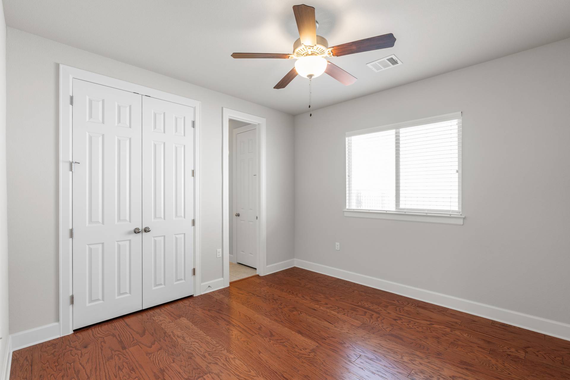 3516 Venezia View Leander, TX 78641 - Photo 18 of 40 Unfurnished bedroom with dark wood-type flooring, a closet, and ceiling fan