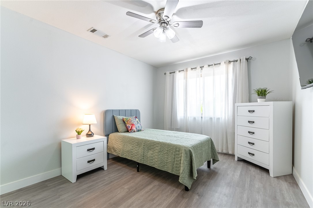105 South Cimarron Road Las Vegas, NV 89145 - Photo 21 of 28 Clean lines and smooth flooring define this light-filled bedroom space.