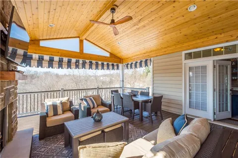 a roof deck with couches and potted plants