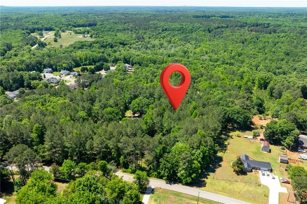 0 Manning Gin Road Monroe, GA 30656 - Photo 2 of 7 an aerial view of a house with a yard and lake view