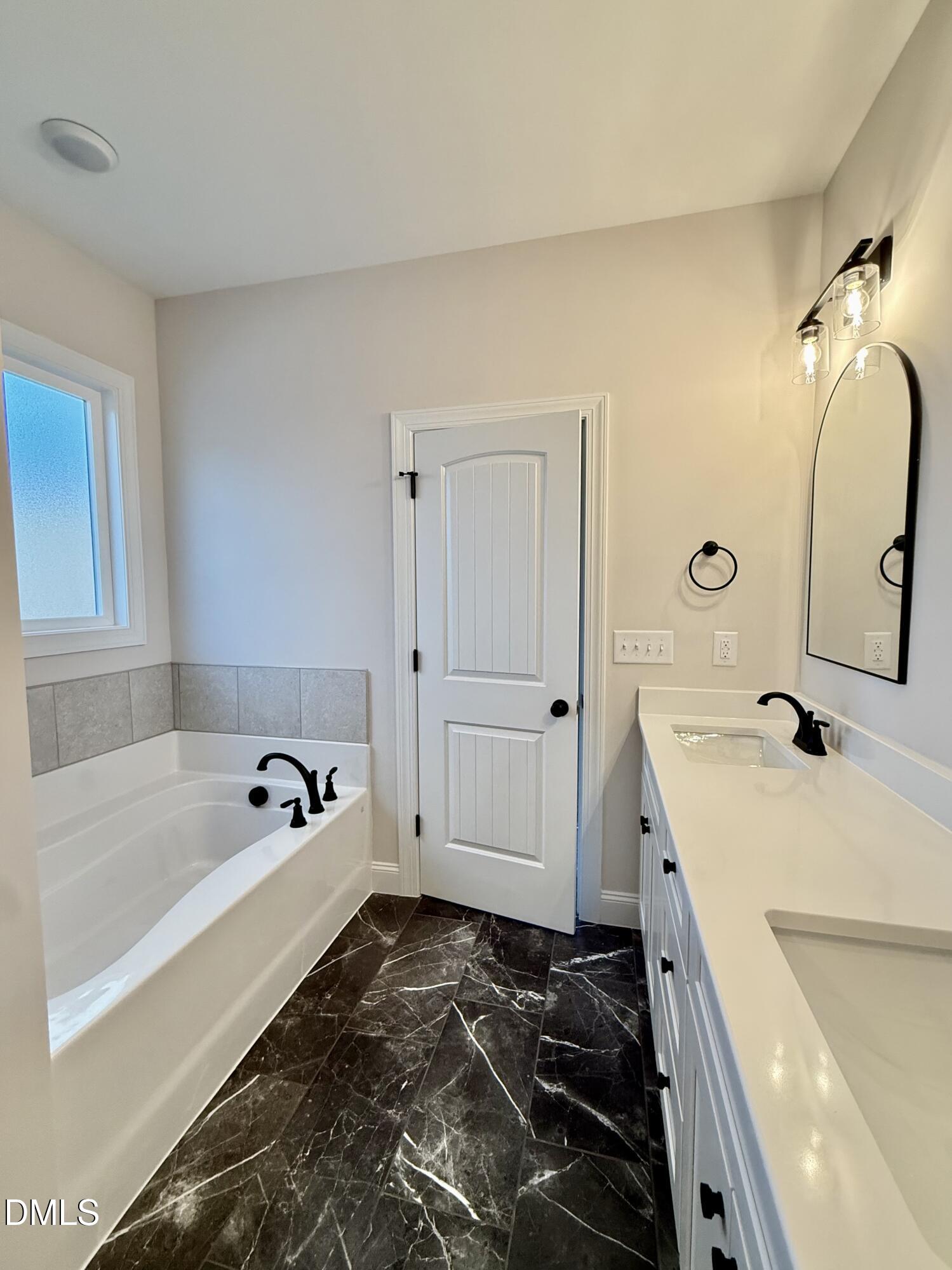 1991 Hayes Road Spring Hope, NC 27882 - Photo 14 of 23 a bathroom with a tub sink and mirror