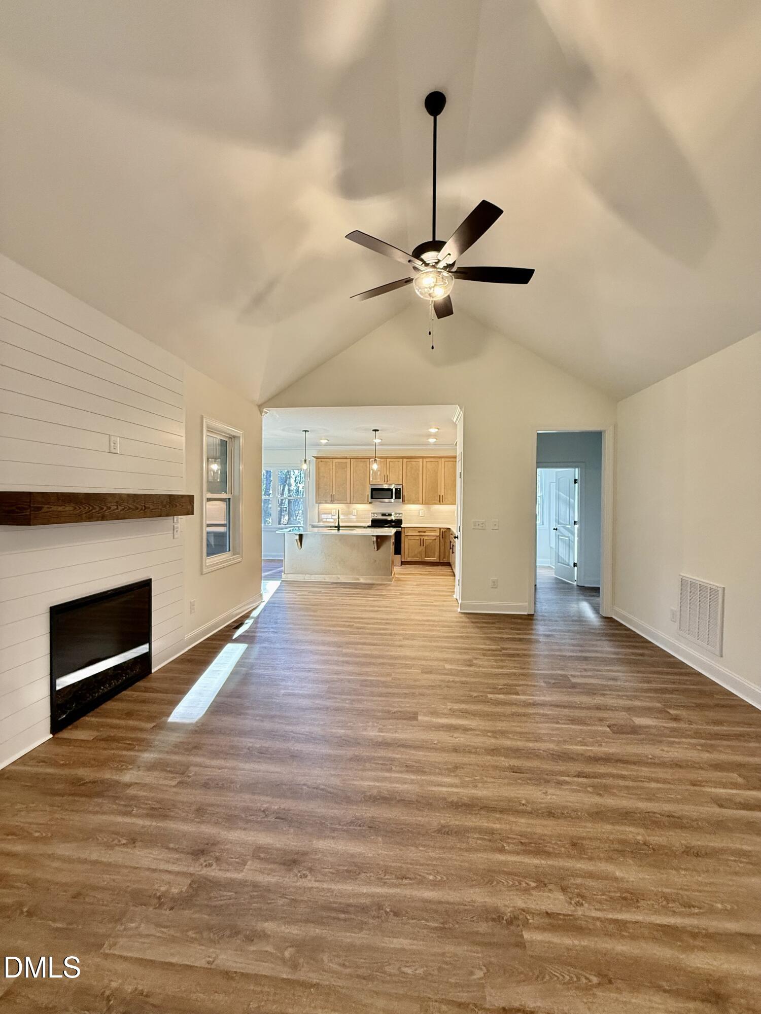1991 Hayes Road Spring Hope, NC 27882 - Photo 6 of 23 a view of a room with a stove wooden floor fireplace and a chandelier