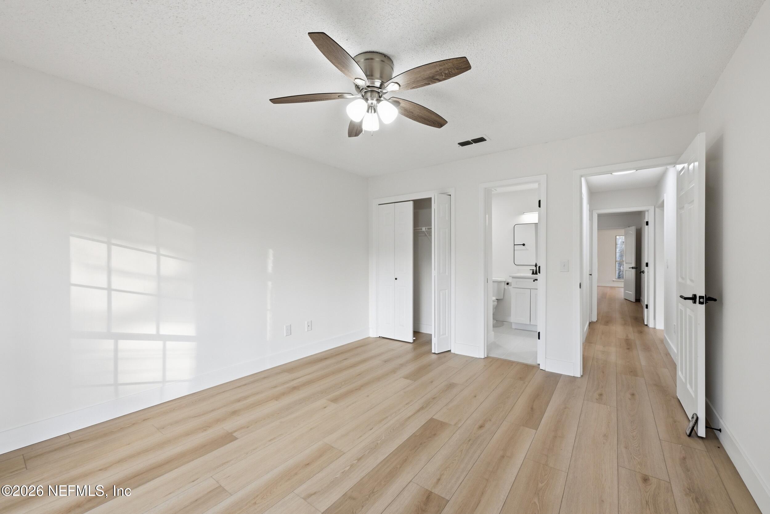 3286 Marbon Road Jacksonville, FL 32223 - Photo 21 of 36 a view of empty room with wooden floor and ceiling fan