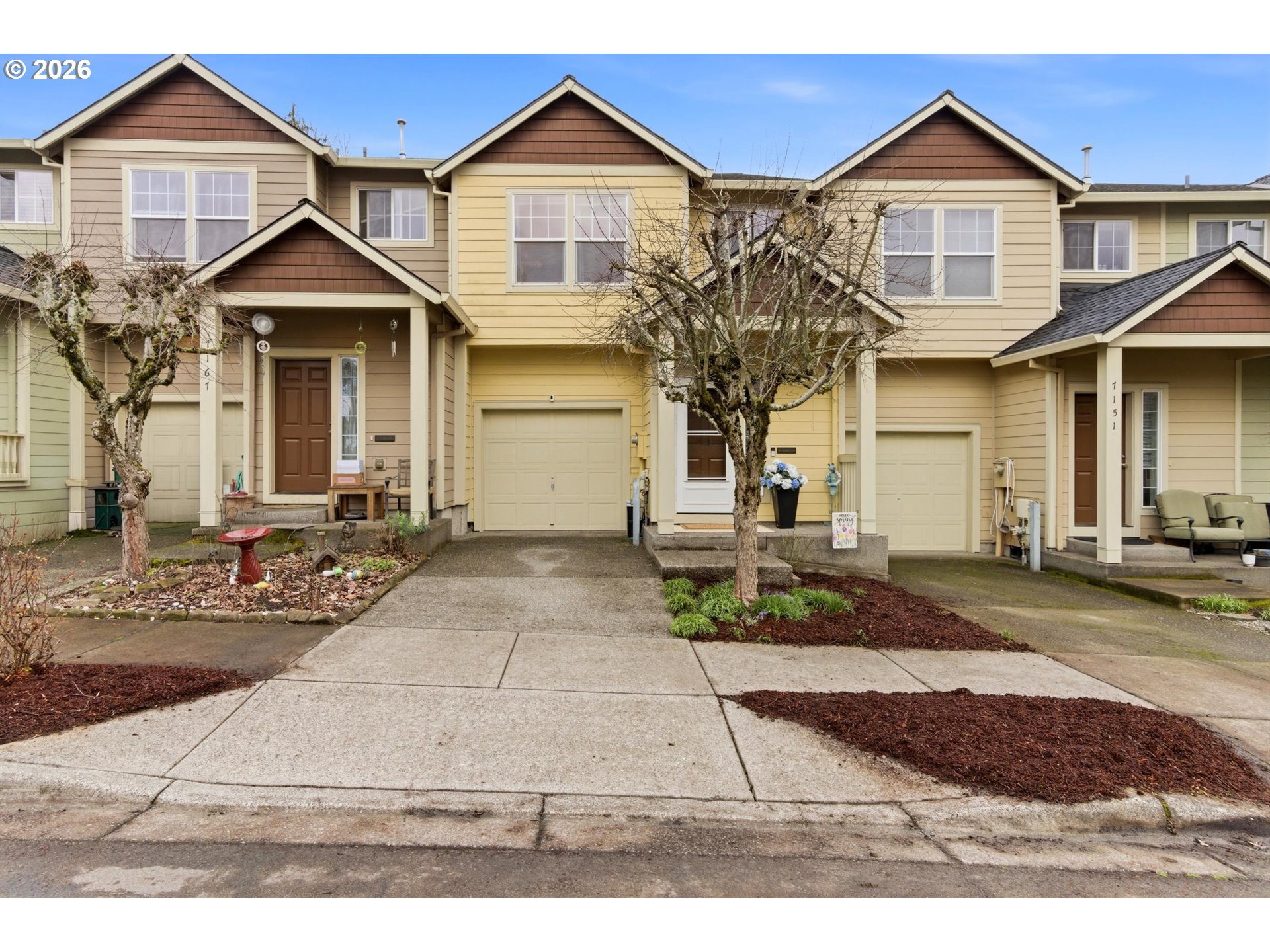 7159 Southwest Millennium Terrace Beaverton, OR 97007 - Photo 1 of 24 a front view of a house with a yard and garage