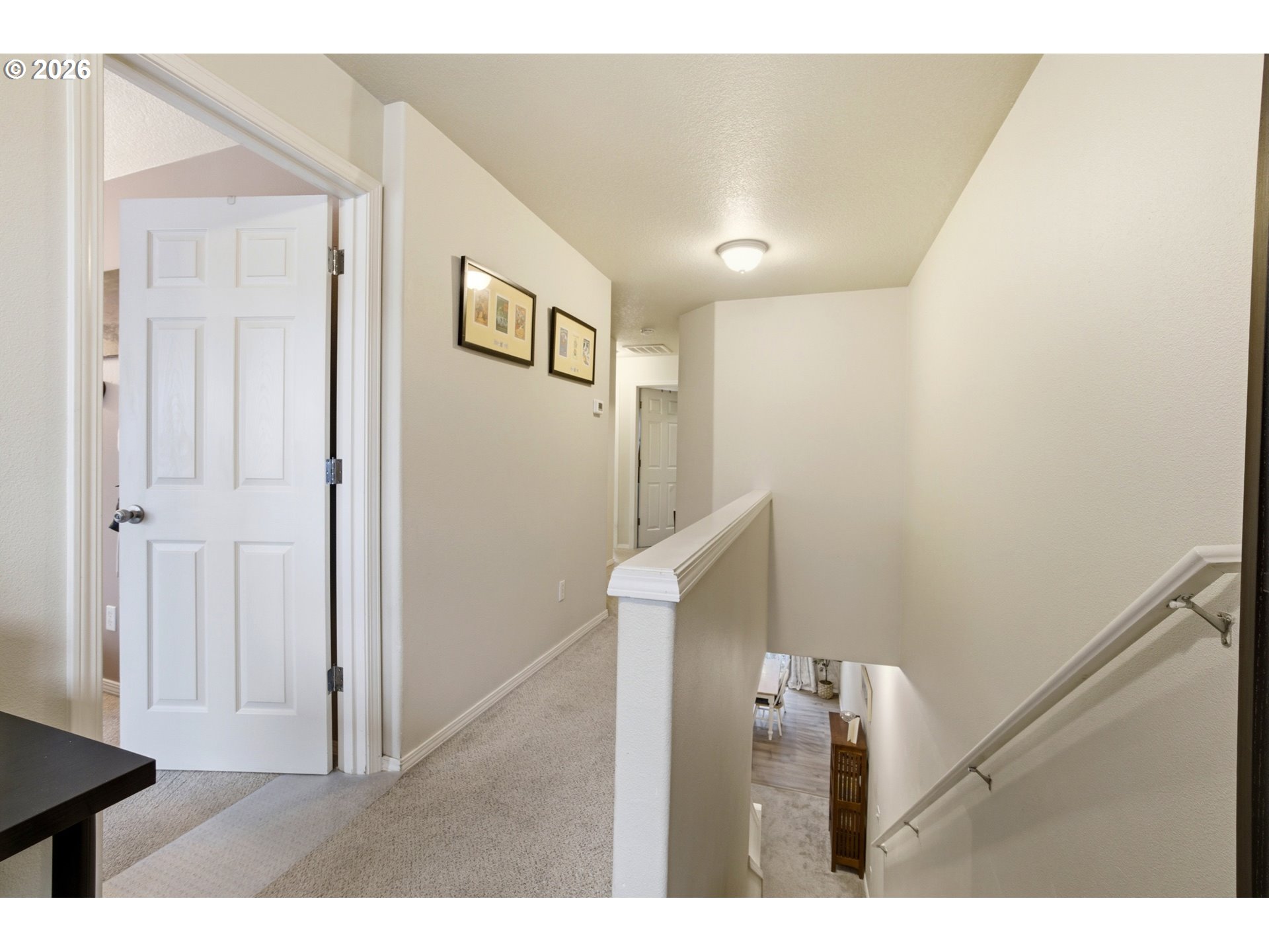 7159 Southwest Millennium Terrace Beaverton, OR 97007 - Photo 13 of 24 a view of hallway with stairs and a wooden floor