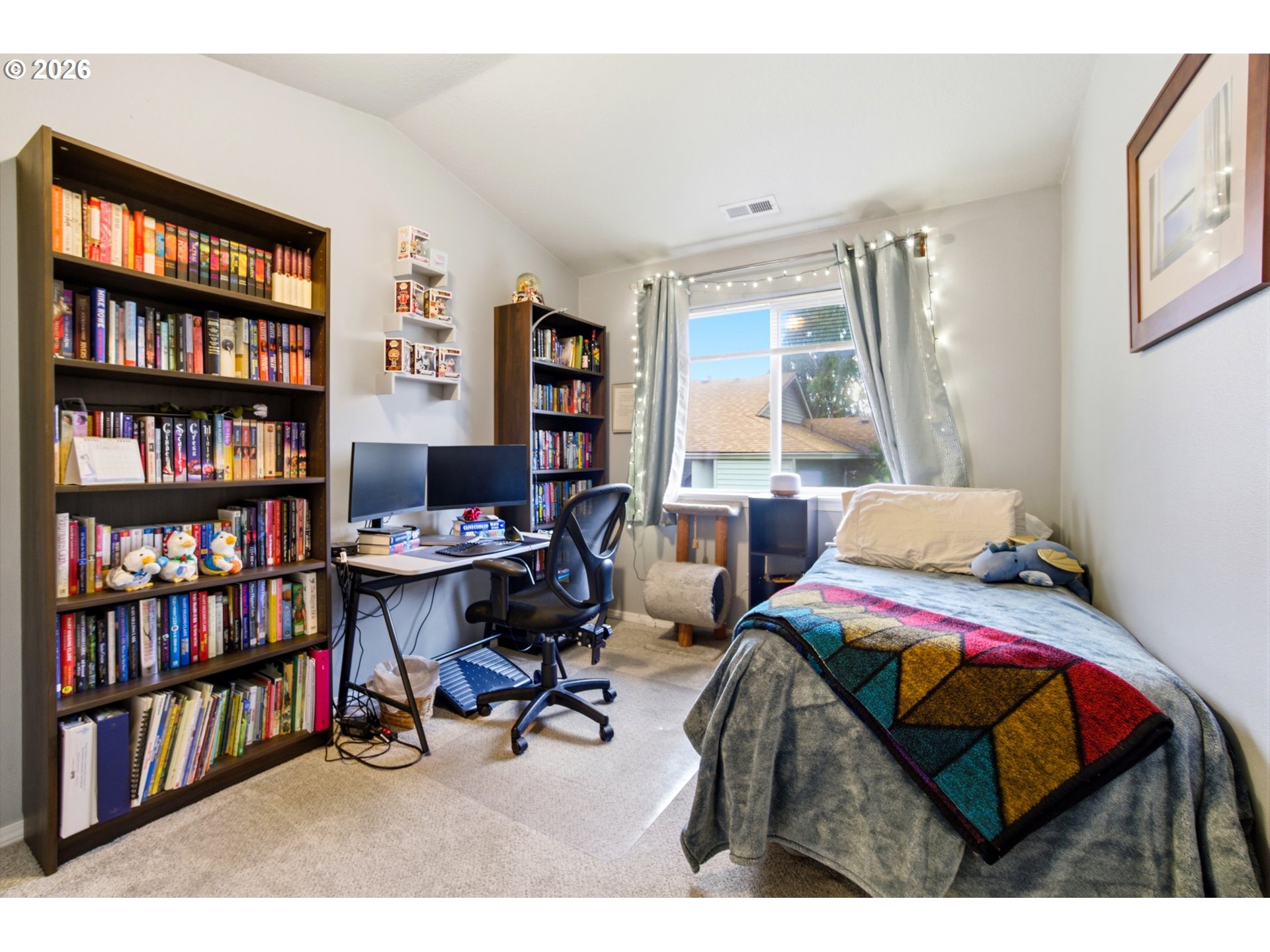 7159 Southwest Millennium Terrace Beaverton, OR 97007 - Photo 19 of 24 a bedroom with a bed a book shelf and a window