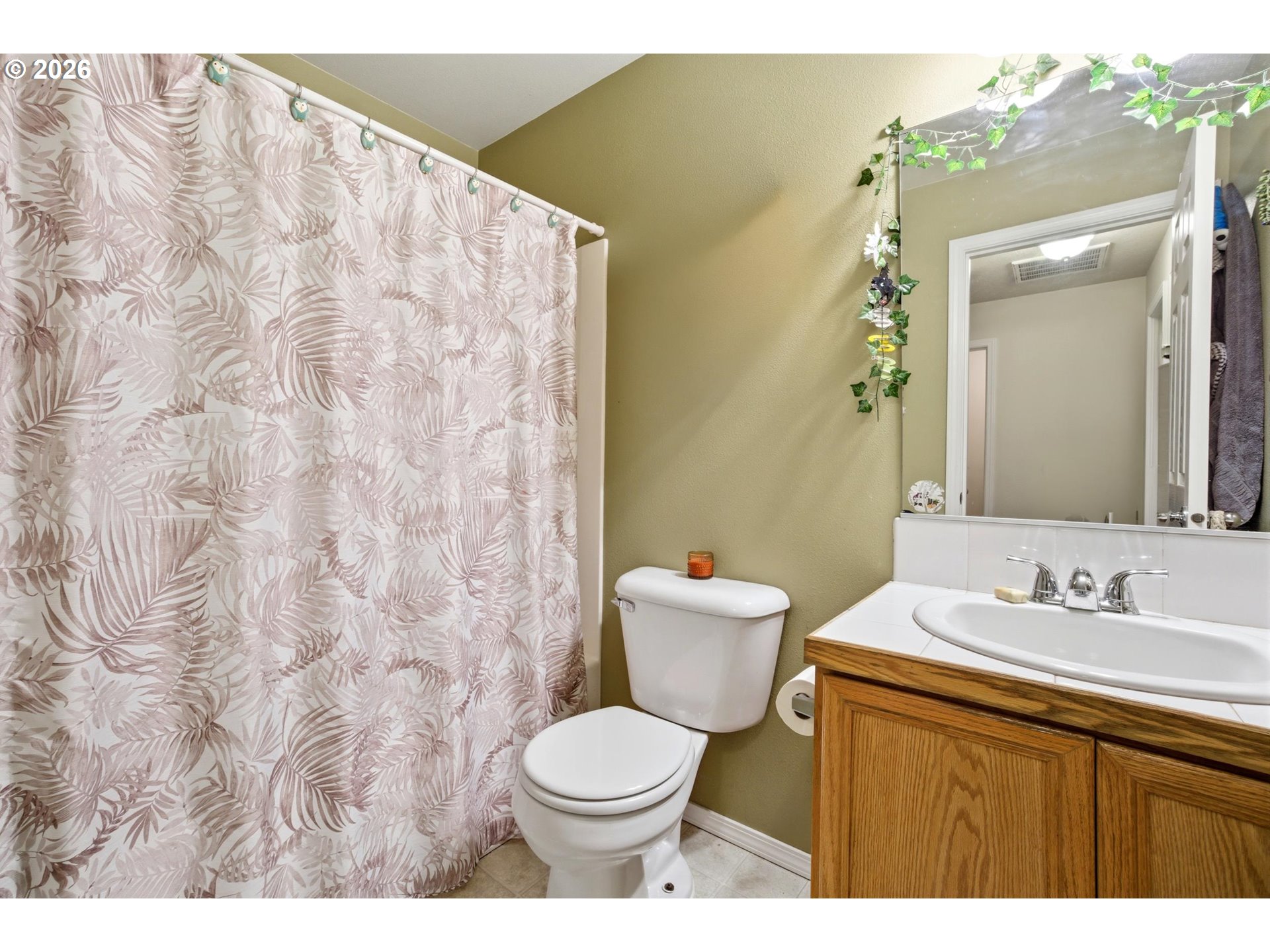 7159 Southwest Millennium Terrace Beaverton, OR 97007 - Photo 20 of 24 a bathroom with a toilet sink and mirror