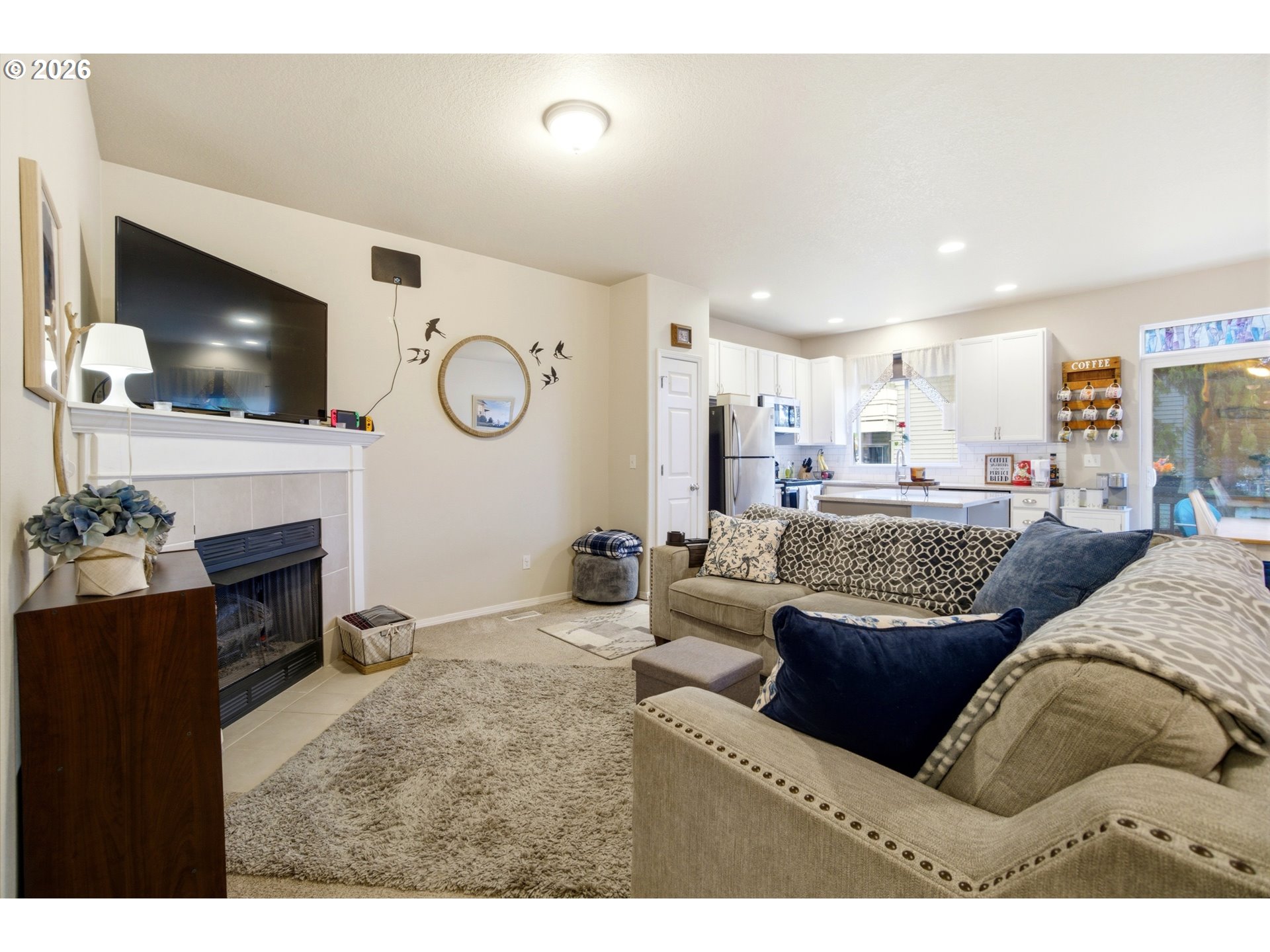7159 Southwest Millennium Terrace Beaverton, OR 97007 - Photo 5 of 24 a living room with fireplace furniture and a flat screen tv