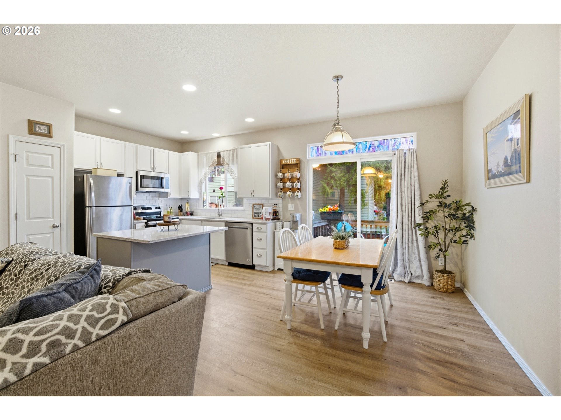7159 Southwest Millennium Terrace Beaverton, OR 97007 - Photo 6 of 24 a living room with kitchen island furniture and a chandelier