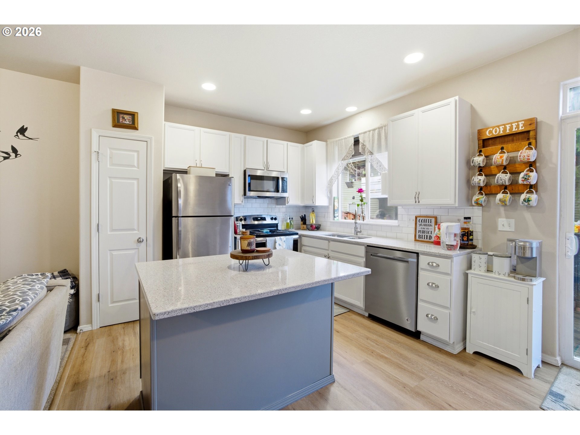 7159 Southwest Millennium Terrace Beaverton, OR 97007 - Photo 7 of 24 a kitchen with white cabinets and stainless steel appliances