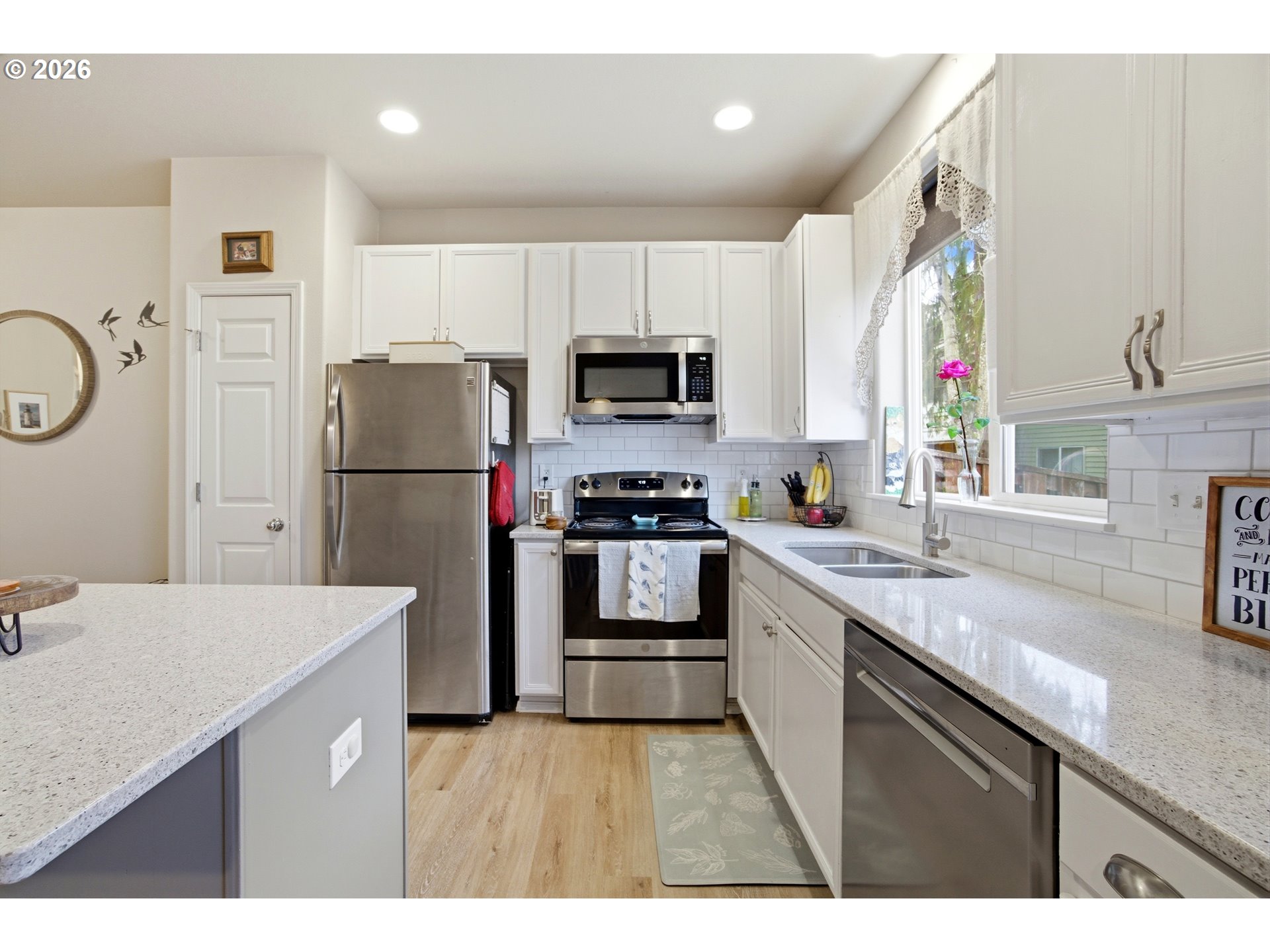 7159 Southwest Millennium Terrace Beaverton, OR 97007 - Photo 8 of 24 a kitchen with granite countertop a refrigerator and a stove top oven