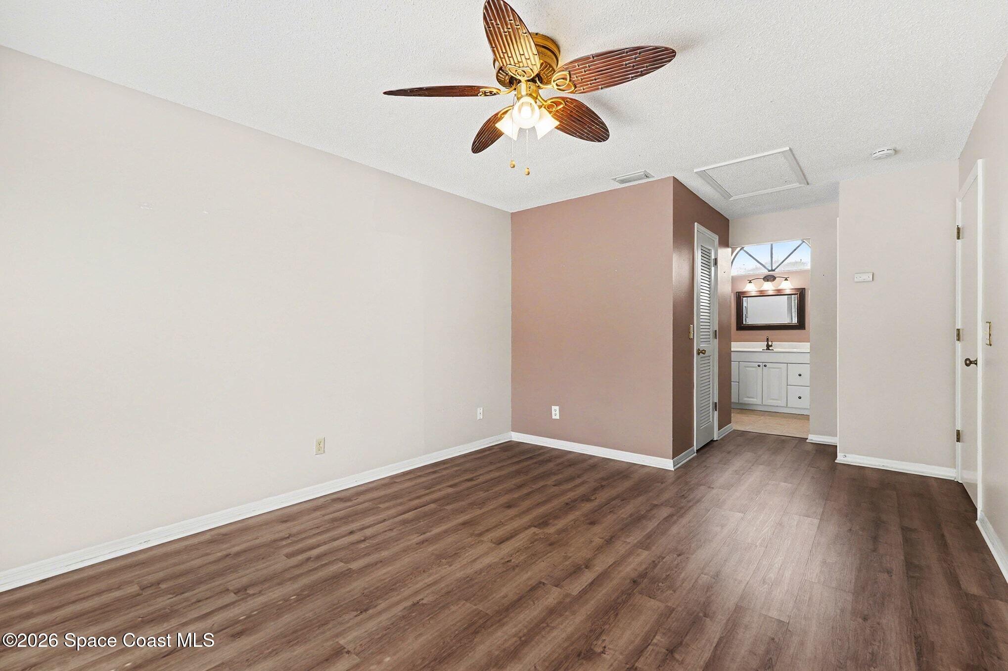 2653 Elliot Way, Unit 6 Melbourne, FL 32935 - Photo 18 of 30 an empty room with wooden floor and a ceiling fan