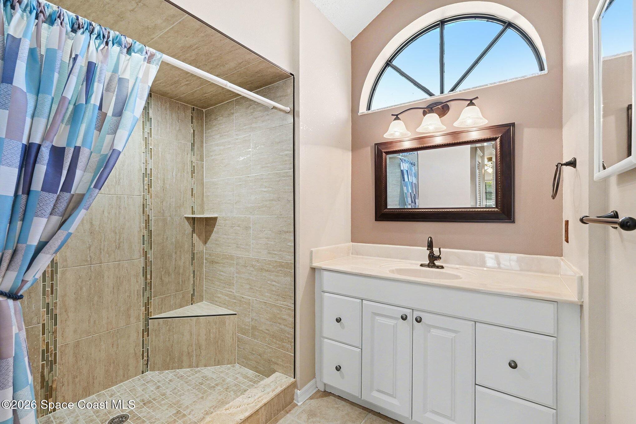 2653 Elliot Way, Unit 6 Melbourne, FL 32935 - Photo 19 of 30 a bathroom with a double vanity sink a mirror and a shower