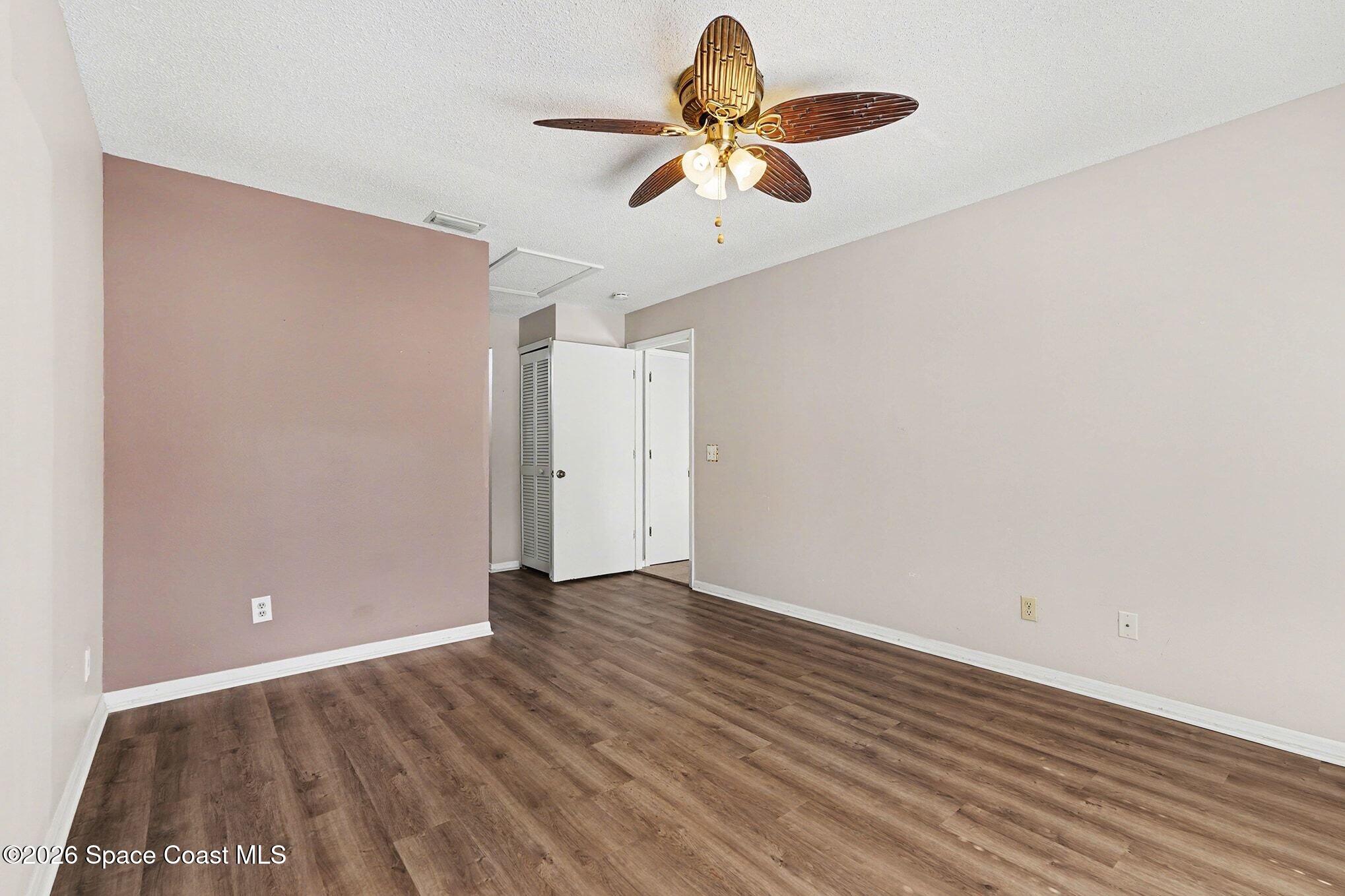 2653 Elliot Way, Unit 6 Melbourne, FL 32935 - Photo 23 of 30 an empty room with wooden floor closet and windows