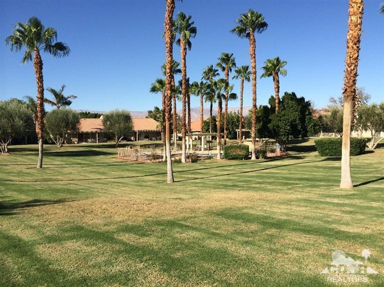 79385 Horizon Palms Circle La Quinta, CA 92253 - Photo 5 of 13 a view of a swimming pool with a garden