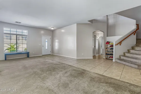 a kitchen with stainless steel appliances granite countertop a stove top oven a sink dishwasher a dining table and chairs with wooden cabinets
