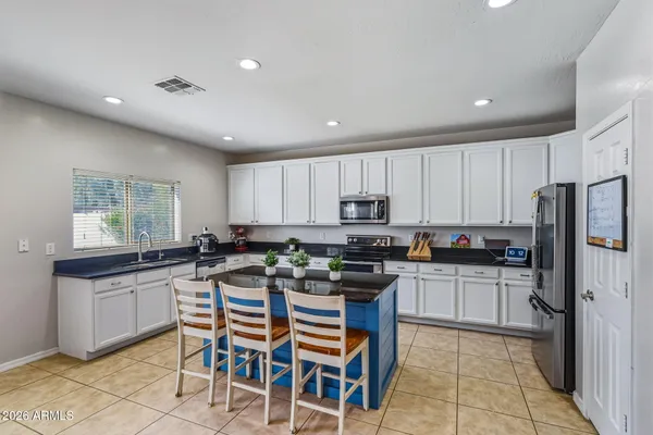 a kitchen with stainless steel appliances granite countertop white cabinets sink and dishwasher
