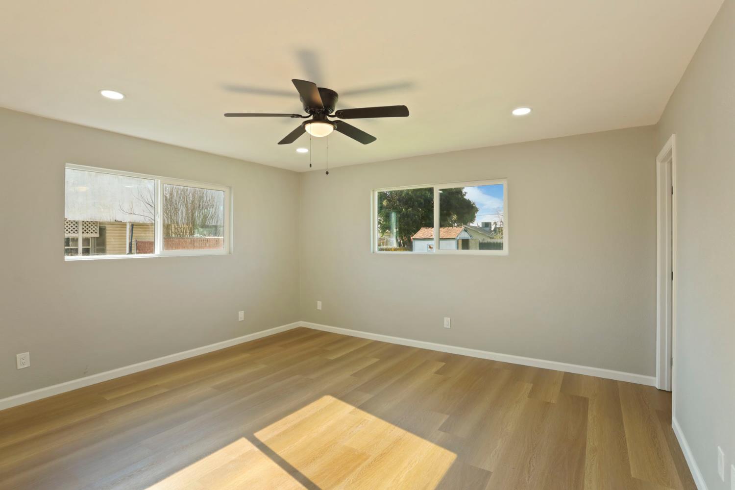 401 Church Street Modesto, CA 95357 - Photo 12 of 28 a view of empty room with wooden floor and window