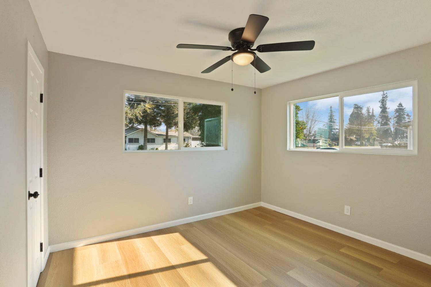 401 Church Street Modesto, CA 95357 - Photo 21 of 28 a view of empty room with wooden floor and fan