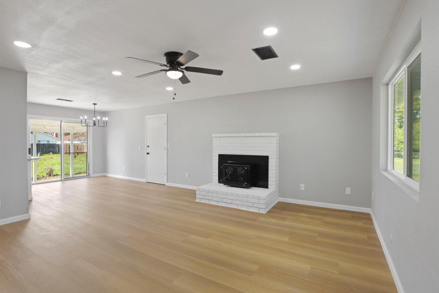 401 Church Street Modesto, CA 95357 - Photo 3 of 28 a view of an empty room with a fireplace and a window