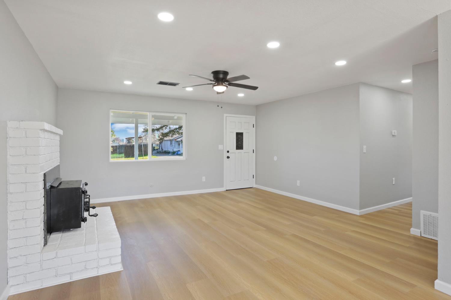401 Church Street Modesto, CA 95357 - Photo 4 of 28 a view of a livingroom with a ceiling fan and wooden floor