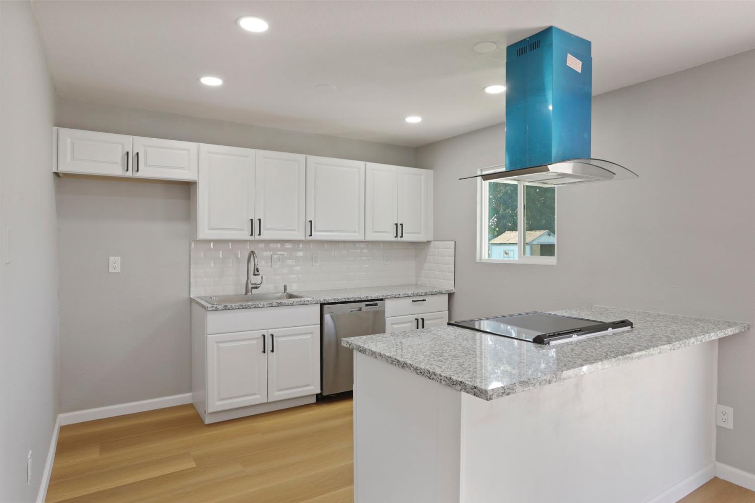 401 Church Street Modesto, CA 95357 - Photo 8 of 28 a kitchen with granite countertop a sink stainless steel appliances and cabinets