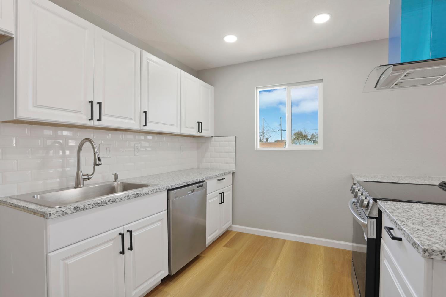 401 Church Street Modesto, CA 95357 - Photo 9 of 28 a kitchen with a sink stove and cabinets