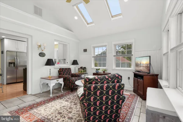 a living room with furniture lamp and rug