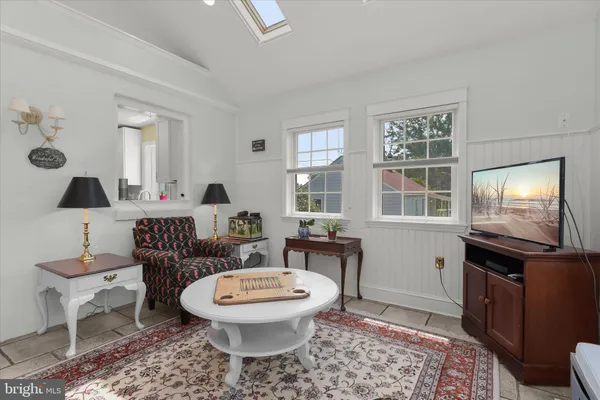 a living room with furniture a window and a lamp