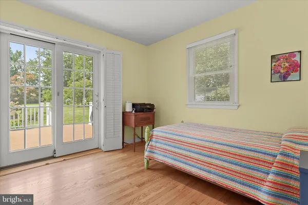 a bedroom with a balcony a bed and a window