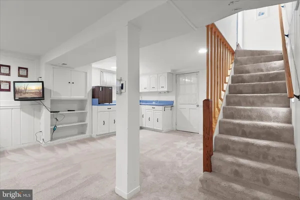 a view of kitchen with furniture and refrigerator