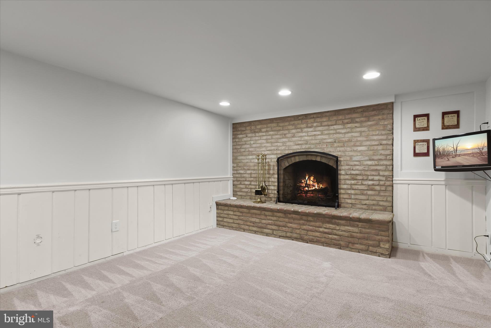12351 Scaggsville Road Highland, MD 20777 - Photo 25 of 43 a view of an empty room with a fireplace and a window