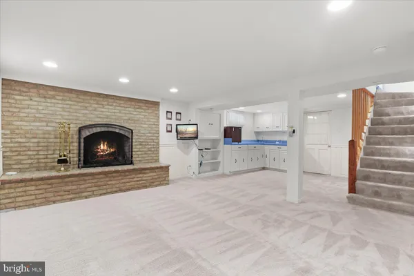 a view of an empty room and fire place