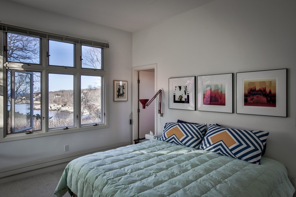 1 Folly Point Road Gloucester, MA 01930 - Photo 20 of 30 a bedroom with a bed and a painting on the wall