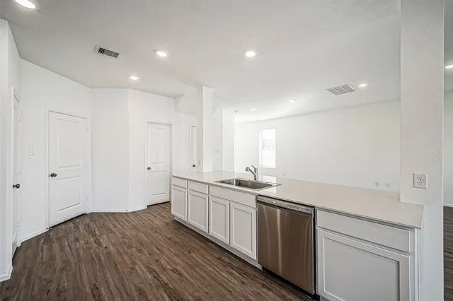 a kitchen with sink and cabinets