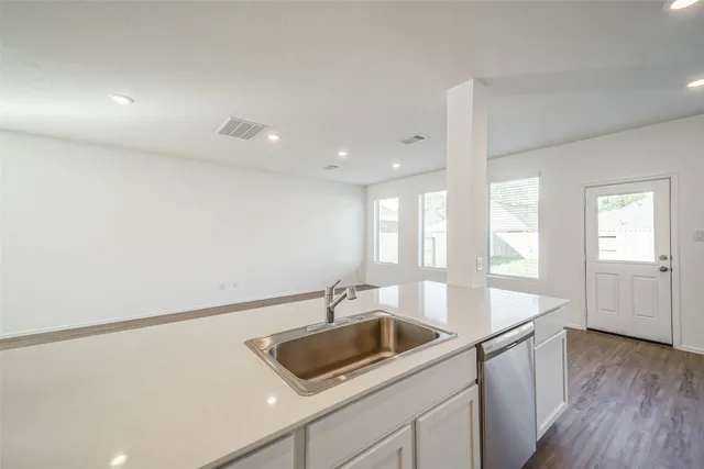 a kitchen with a sink and a refrigerator