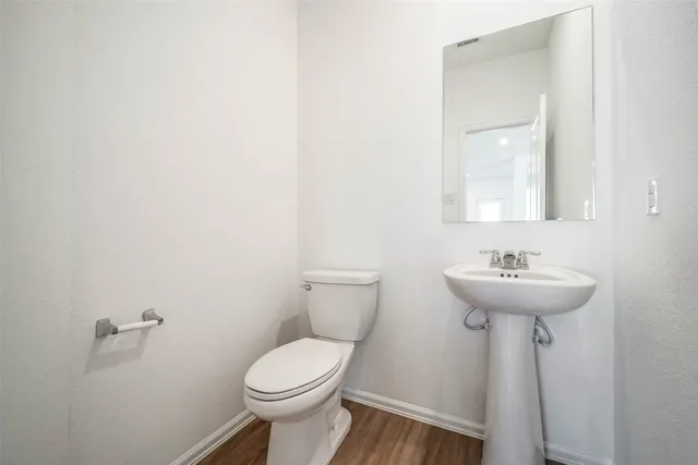 a bathroom with a sink a mirror and a toilet