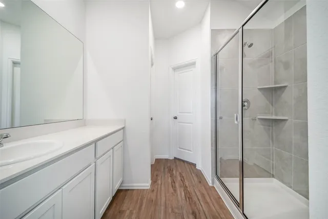 a bathroom with a sink and glass door