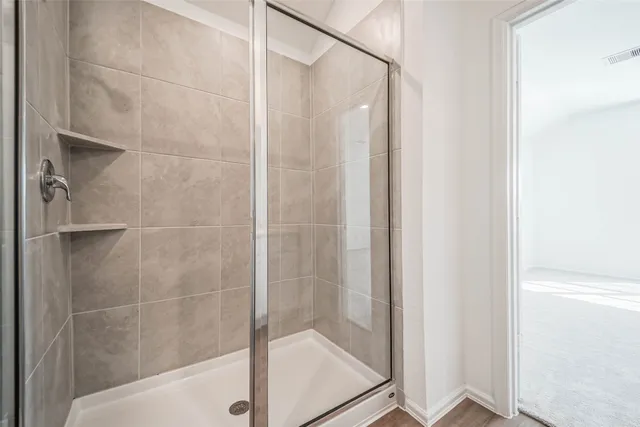 a bathroom with a glass shower door