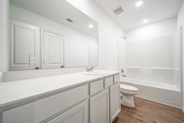 a bathroom with a sink a toilet and a bathtub