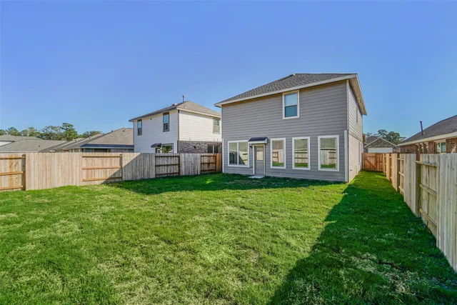 a view of a house with backyard and porch